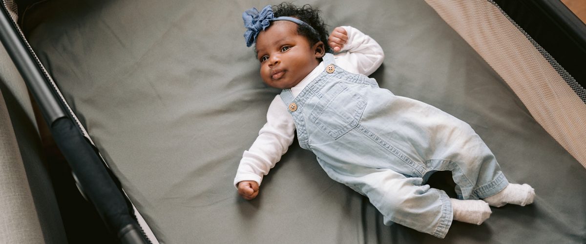 Baby lying on back in crib