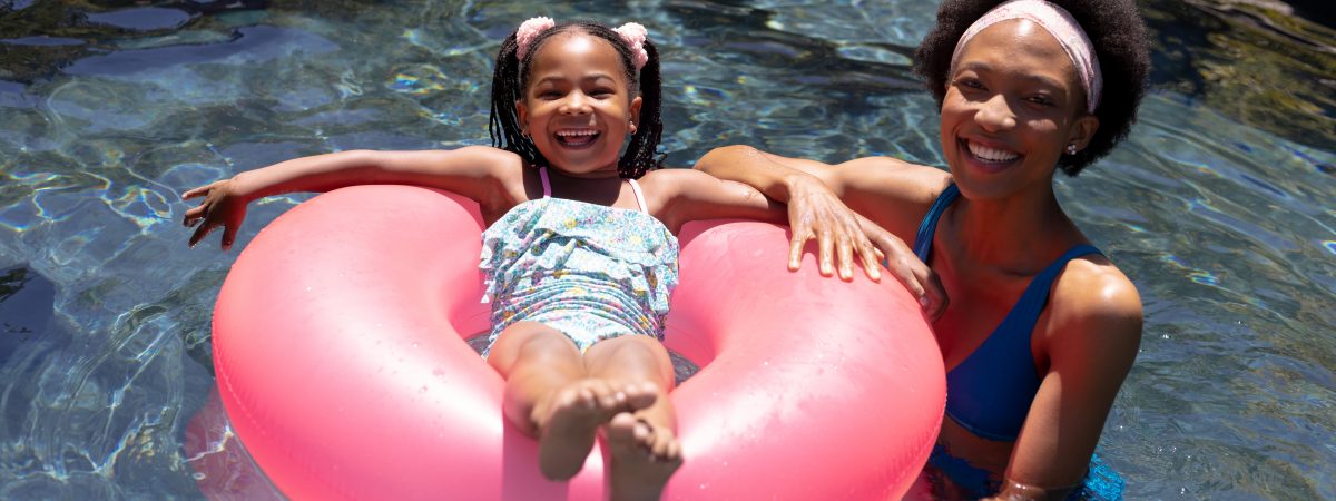 Adult and child in a swimming pool.